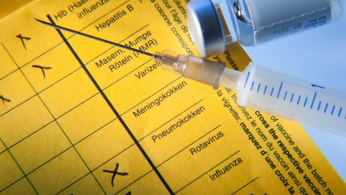 Impfung_AdobeStock_83942173_edited.jpg Spritze mit Impfausweis